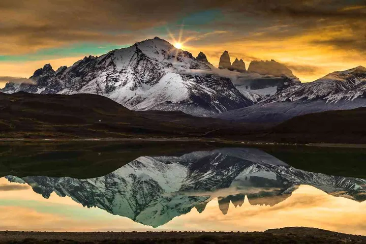 The Paine Massif reflected in the water at sunrise