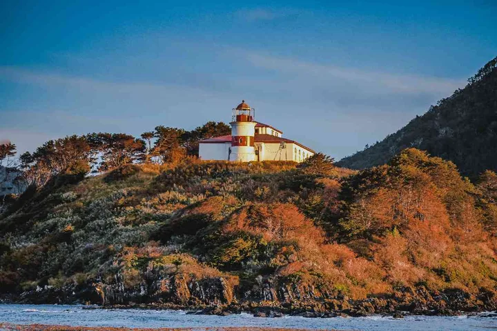 San Isidro Lighthouse between the forest and the Strait of Magellan